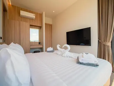 a bedroom with a large white bed with towels on it at Elegant Aileen 3Bed Pool Villa P3VC8 Naithon in Phuket Town