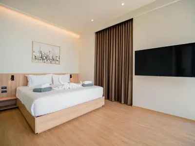 a bedroom with a large bed and a flat screen tv at Elegant Aileen 3Bed Pool Villa P3VC8 Naithon in Phuket Town