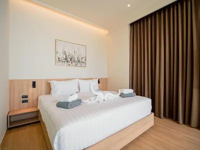 a hotel room with a large white bed and a window at Elegant Aileen 3Bed Pool Villa P3VC8 Naithon in Phuket Town