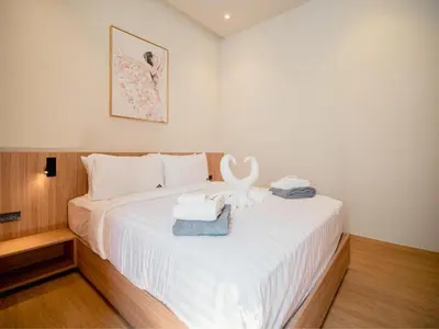 a bedroom with a white bed with towels on it at Elegant Aileen 3Bed Pool Villa P3VC8 Naithon in Phuket Town