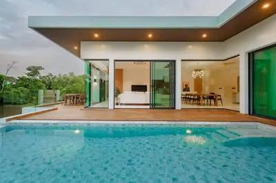 a swimming pool in front of a house at Niva Villa - Modern & Lake View near Phuket town in Ban Bang Khu