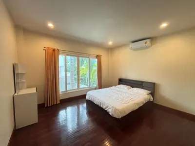 a bedroom with a bed and a large window at NS Private Pool villa in Ban Na Kok