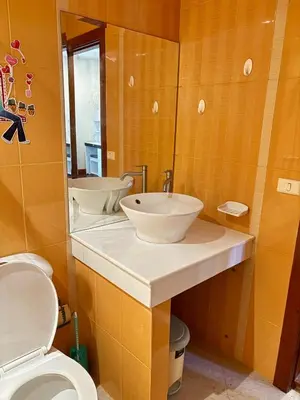a bathroom with two sinks and a toilet at NS Private Pool villa in Ban Na Kok