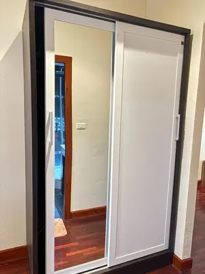 a sliding glass door with a mirror in a room at NS Private Pool villa in Ban Na Kok