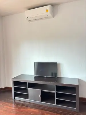 a entertainment center with a television on top of it at NS Private Pool villa in Ban Na Kok