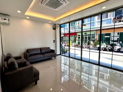 a living room with two couches and a large window at Black Pantera House in Patong Beach