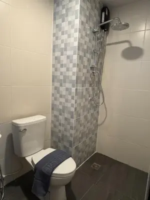 a bathroom with a toilet and a shower at Black Pantera House in Patong Beach