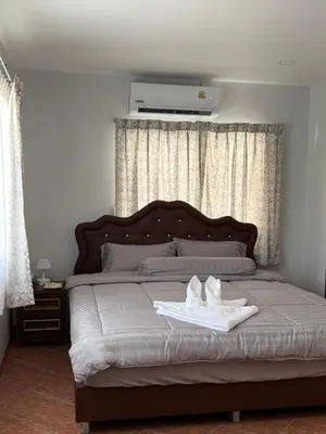 a bedroom with a bed with two towels on it at B&K private pool Villa in Rawai Beach