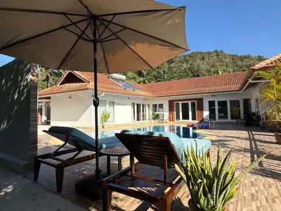 a patio with a table and chairs and an umbrella at B&K private pool Villa in Rawai Beach
