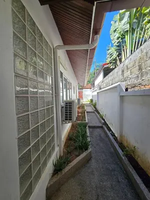 a walkway leading to a building with a wall at B&K private pool Villa in Rawai Beach