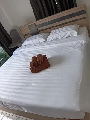 a pair of towels sitting on a bed at Kamala House in Kamala Beach