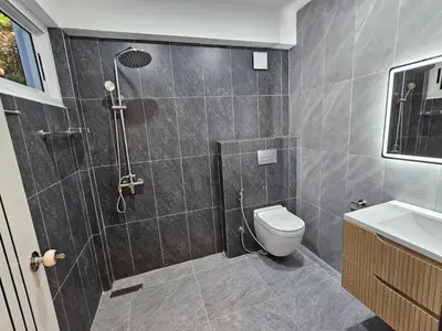 a bathroom with a shower and a toilet at Kamala House in Kamala Beach