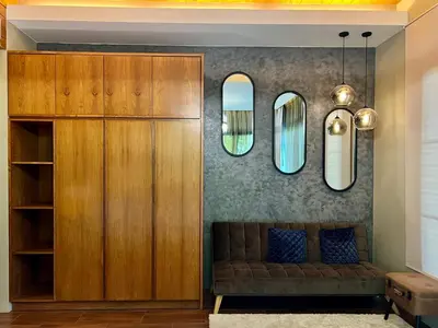a living room with a couch and two mirrors at 3-bdr Premium Villa in Nai Harn Baan Bua by Neo With Love in Phuket Town