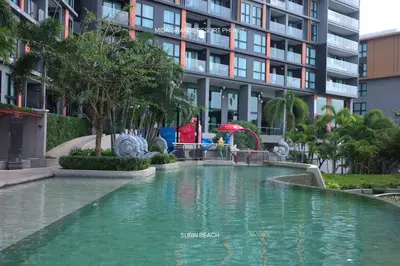 a swimming pool in front of a tall building at Suite With Sea View By Mida Grande Resort in Ban Lum Fuang