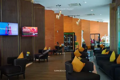 a waiting room with couches and chairs and a tv at Suite With Sea View By Mida Grande Resort in Ban Lum Fuang