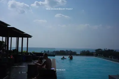 a group of people sitting in a swimming pool at Suite With Sea View By Mida Grande Resort in Ban Lum Fuang
