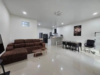 a living room with a couch and a dining room at Rawai 4 Bedrooms Private Pool Villa in Rawai Beach