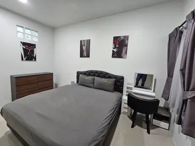 a bedroom with a bed and a desk with a laptop at Rawai 4 Bedrooms Private Pool Villa in Rawai Beach