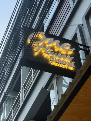 a sign for a restaurant on the side of a building at One Houses in Patong Beach