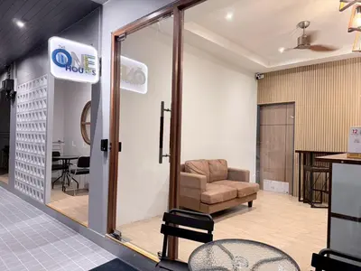 a room with a chair and a glass door at One Houses in Patong Beach
