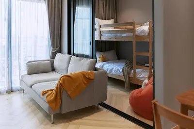 a living room with a couch and a bunk bed at Brand New 2-BR apartment, only 7 min to the beach! in Bang Tao Beach