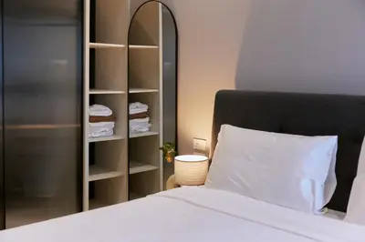 a bedroom with a white bed and a closet at Brand New 2-BR apartment, only 7 min to the beach! in Bang Tao Beach