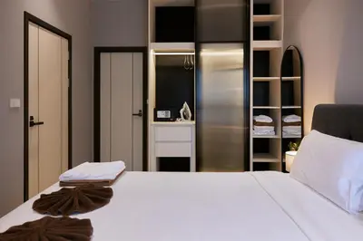 a bedroom with a white bed and a closet at Brand New 2-BR apartment, only 7 min to the beach! in Bang Tao Beach