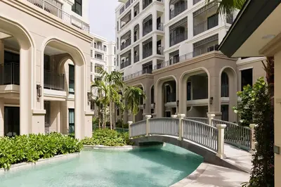 a swimming pool in front of a building at Brand New 2-BR apartment, only 7 min to the beach! in Bang Tao Beach