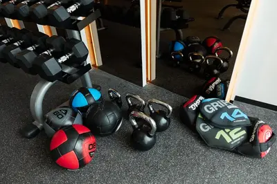 a pile of balls and dumbbells in front of a mirror at Brand New 2-BR apartment, only 7 min to the beach! in Bang Tao Beach