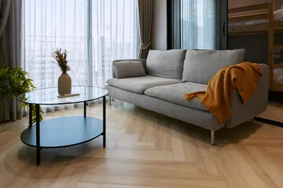 a living room with a couch and a table at Brand New 2-BR apartment, only 7 min to the beach! in Bang Tao Beach