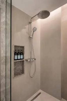 a shower with a shower head in a bathroom at Потрясающие апартаменты на Банг Тао in Laguna Phuket