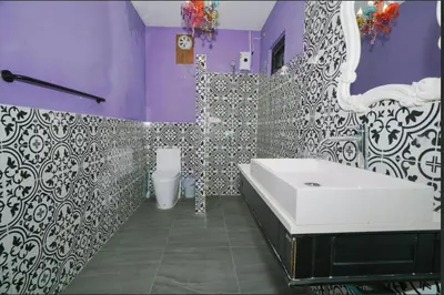a purple bathroom with a tub and a toilet at Beautiful 4 bedroom ocean view white house, steps from the beach Rawai Beach in Nai Harn Beach
