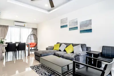 a living room with a couch and a table at Laguna Cozy 3 bedroom town house 800m to beach in Laguna Phuket