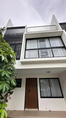 a white house with a brown door and windows at Laguna Cozy 3 bedroom town house 800m to beach in Laguna Phuket
