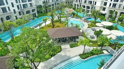an aerial view of a resort with two swimming pools at Bright Modern Phuket Home Title Legendary Bangtao in Bang Tao Beach