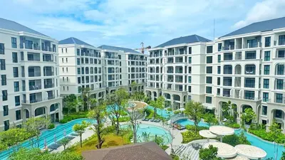 an apartment complex with a swimming pool and buildings at Bright Modern Phuket Home Title Legendary Bangtao in Bang Tao Beach