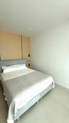 a bedroom with a large white bed in it at The Regent new apartment in Ban Thalat Choeng Thale