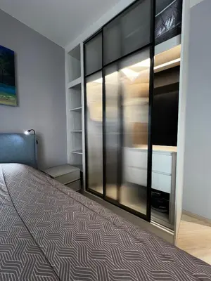 a bedroom with a bed and a large window at Title Legendary suite pool view E301 in Phuket
