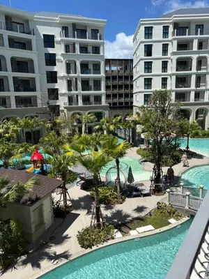 an aerial view of a resort with two pools and palm trees at Title Legendary suite pool view E301 in Phuket