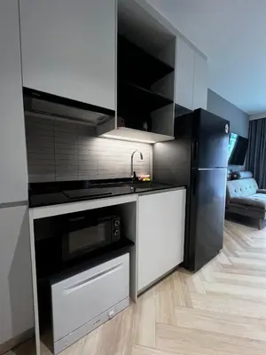 a kitchen with a sink and a refrigerator at Title Legendary suite pool view E301 in Phuket