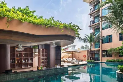 a swimming pool in front of a building at The Proud Karon Phuket - New 1BR Apartment 6floor in Karon Beach