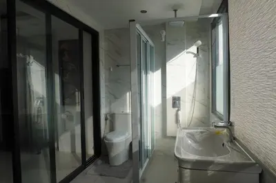 a bathroom with a toilet and a sink and a shower at Patong Condo Tub, Roof Pool & 2-min to Beach in Patong Beach