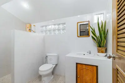 a white bathroom with a toilet and a sink at V278 Quiet Poolside 3BR Villa for Relaxed Stays in Ban Bang Chak