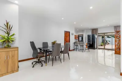 a dining room with a table and chairs at V278 Quiet Poolside 3BR Villa for Relaxed Stays in Ban Bang Chak