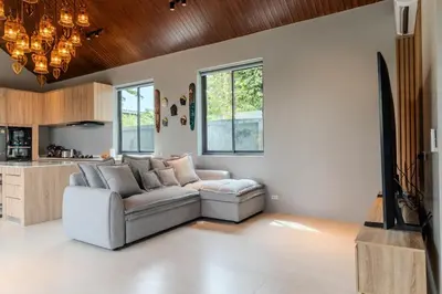 a living room with a couch and a table at V280 If You Need Luxury This Is The Place Fully Smart in Ban Saiyuan (1)