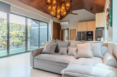 a living room with a couch and a kitchen at V280 If You Need Luxury This Is The Place Fully Smart in Ban Saiyuan (1)