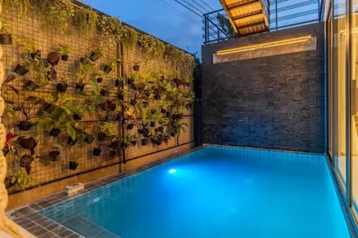 an indoor swimming pool with blue lights on a brick wall at V280 If You Need Luxury This Is The Place Fully Smart in Ban Saiyuan (1)