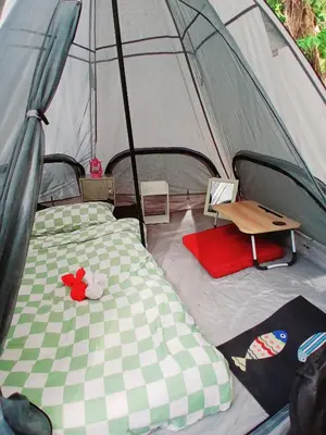 a tent with a bed and a table in it at Kalaland camp tant Patong in Patong Beach