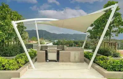 a pavilion with a picnic table under a white canopy at Apartments in the center of Laguna in Laguna Phuket