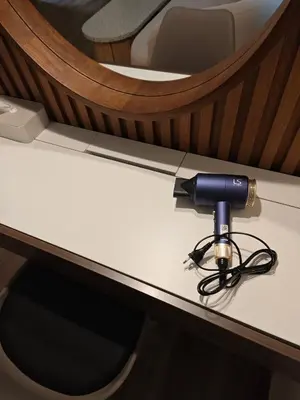 a table with a hair dryer on top of it at Tangerine Villa Patong in Patong Beach